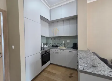 Modern kitchen with light-colored cabinets and a breakfast bar. - image 5