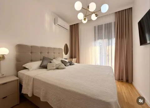 Modern and tidy bedroom with a double bed and a large window. - image 7