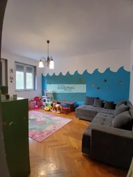 Dnevna soba sa ugaonom garniturom, parketom na podu i dečjim kutkom. - image 8
