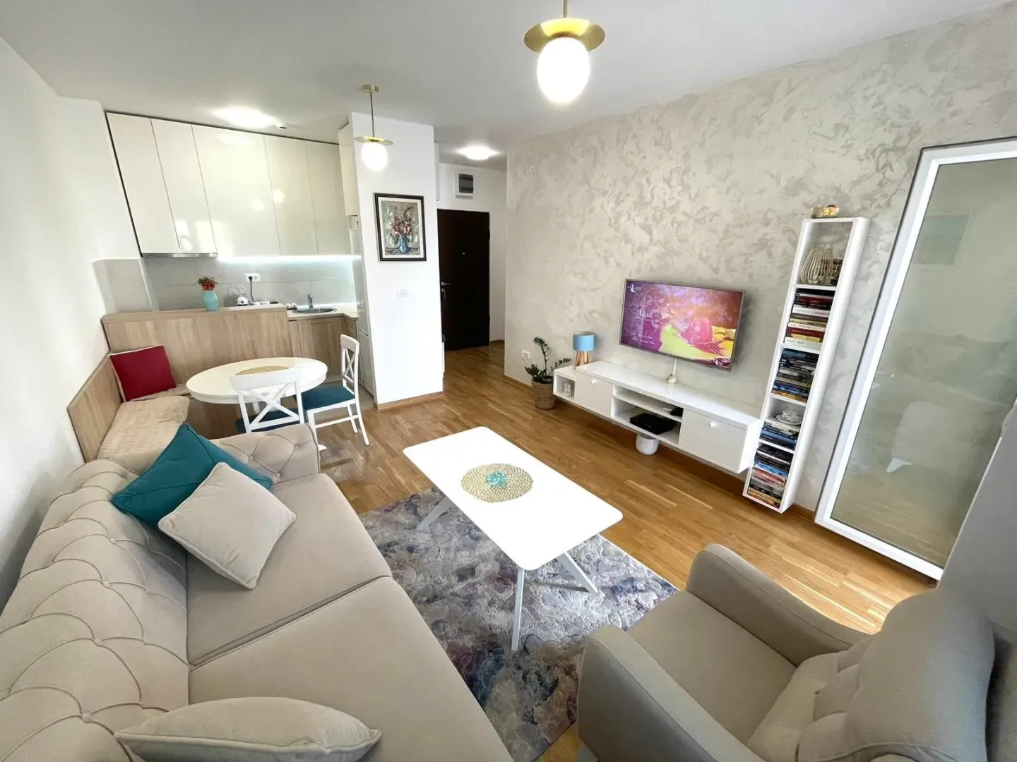 Modern and bright living room with a sofa and dining area.