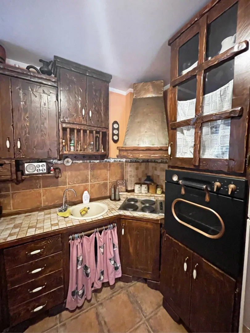 Rustic kitchen with wooden cabinets.