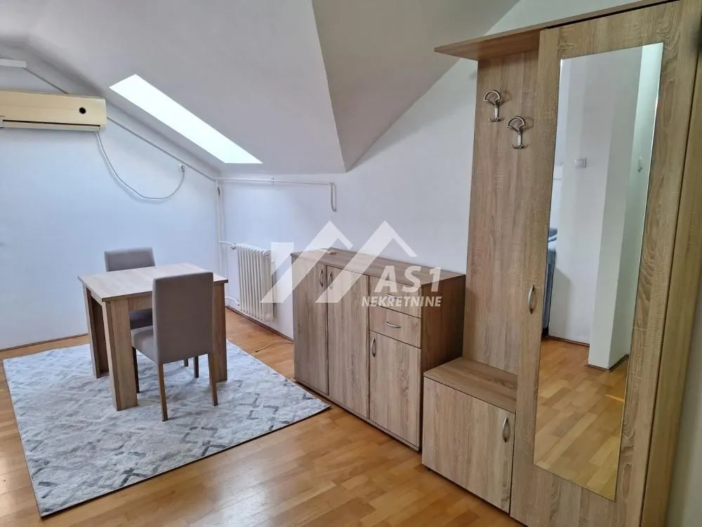 Living room with a dining table and wooden furniture.
