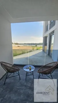 Natkrivena terasa sa garniturom za sedenje i pogledom na reku. - image 12