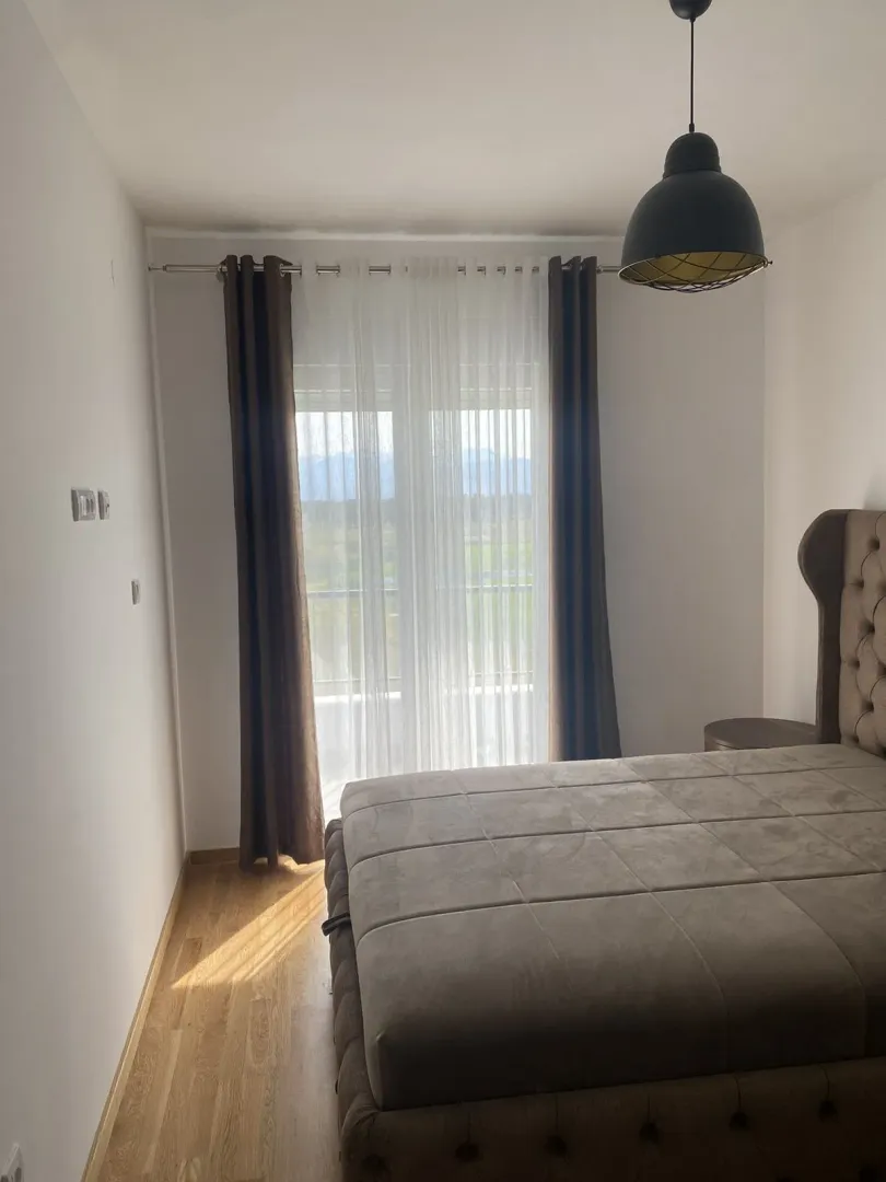 Bright bedroom with a large bed and a window.