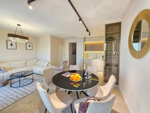 Living room with dining area and kitchen in an open space layout. - image 3