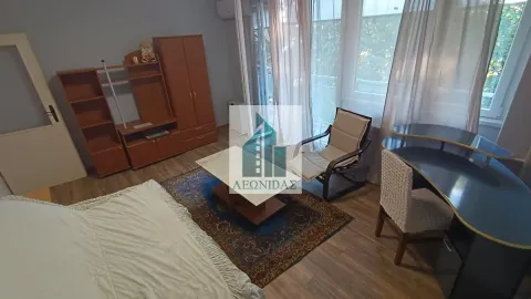 Furnished bedroom with a bed, wardrobe, and desk. - image 2