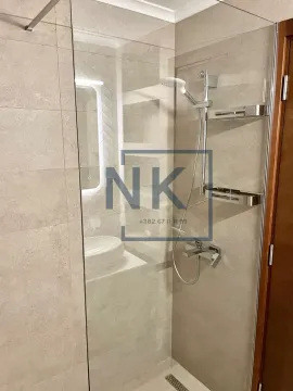 Modernly equipped bathroom with a walk-in shower. - image 11