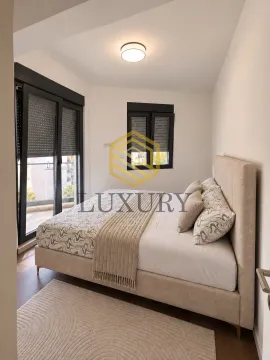 Bright bedroom with a double bed and balcony access. - image 3