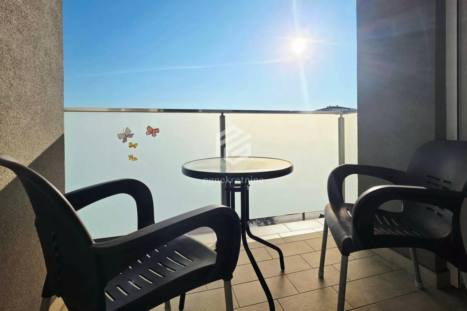 Furnished balcony with a table and two chairs.