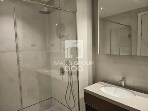 Modern bathroom with a walk-in shower and vanity washbasin. - image 13