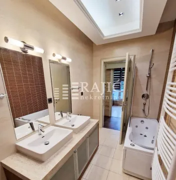 Modern bathroom with two sinks, a bathtub and a whirlpool tub. - image 5