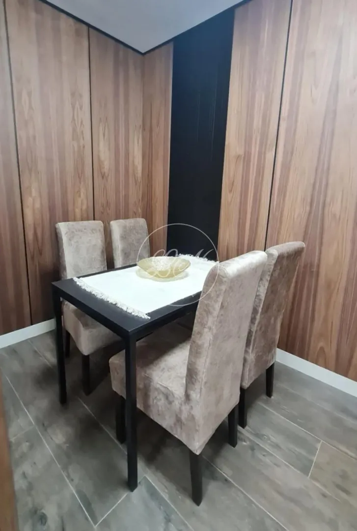 Dining table with four upholstered chairs in the living room.