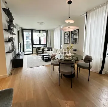 Living room with dining area and modern furniture. - image 2