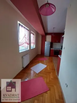 Spacious kitchen with a dining area, hardwood parquet flooring, and windows overlooking the exterior. - image 4