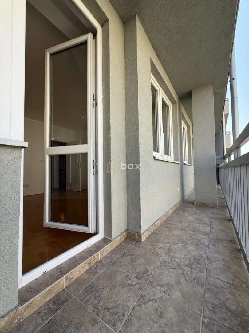 Long tiled balcony with access to the interior.