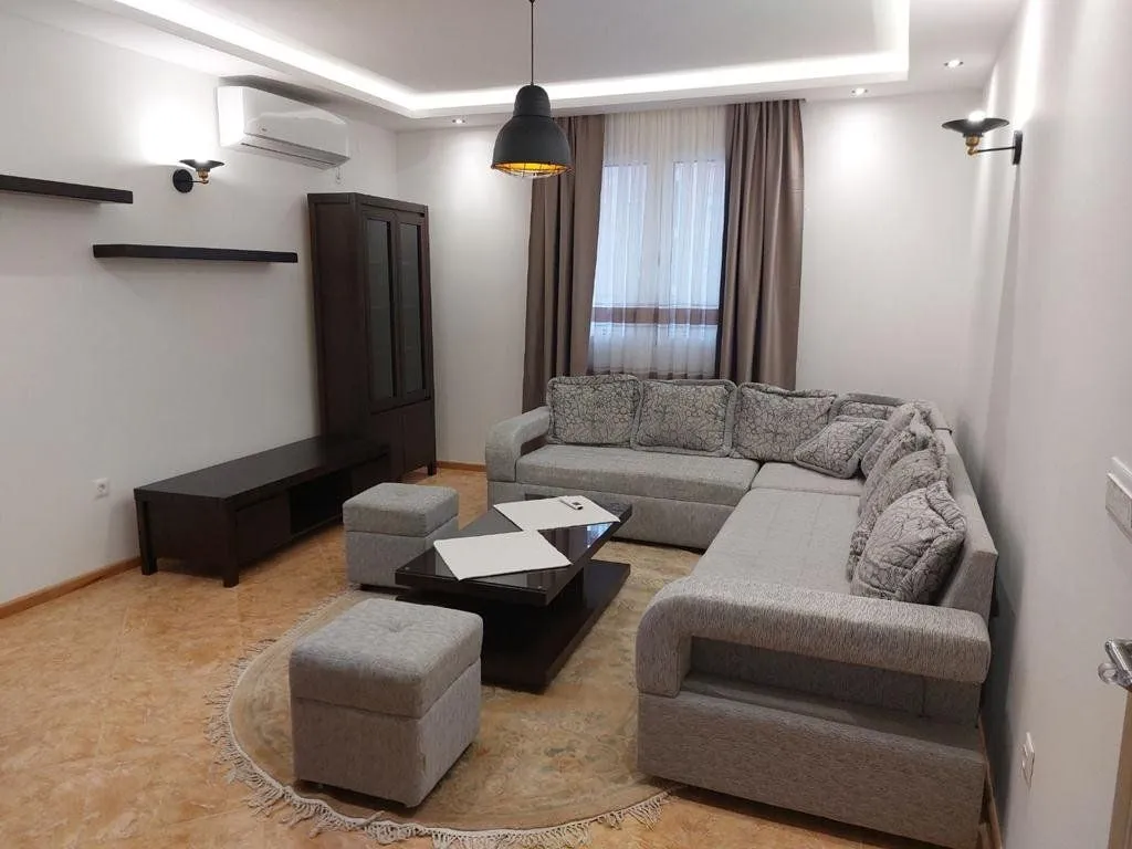Living room with a sectional sofa, coffee table, and cabinet.