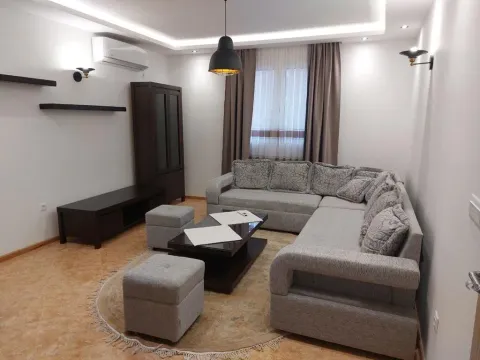 Living room with a sectional sofa, coffee table, and cabinet. - image 5