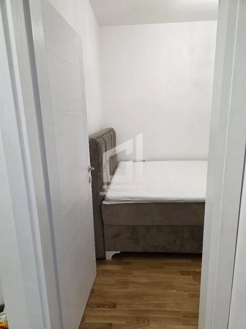 View from the hallway into a small bedroom with a bed.