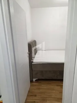 View from the hallway into a small bedroom with a bed. - image 5