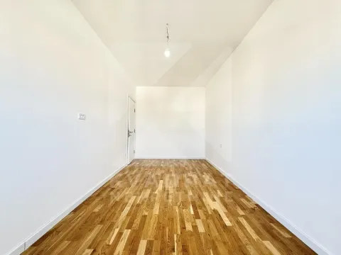 Empty room with white walls and wooden flooring. - image 5