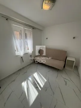 Manja soba sa kaučem i prozorom sa belim zavesama. - image 14