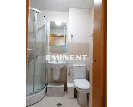Bathroom equipped with a shower cabin, washbasin, and toilet. - image 9
