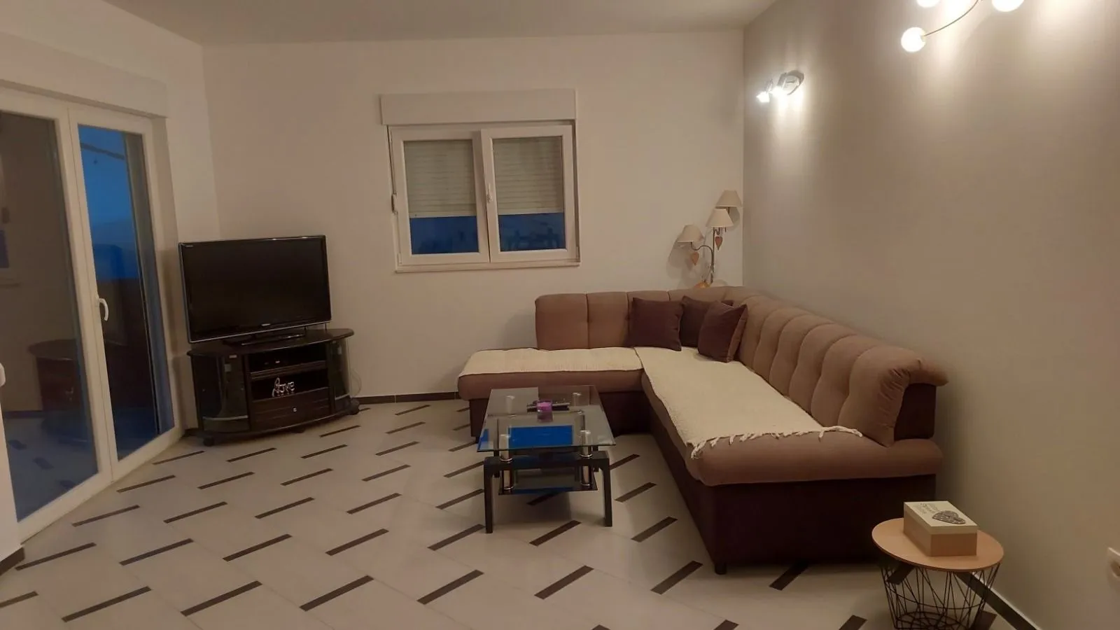 Living room with a sectional sofa, TV, and coffee table.