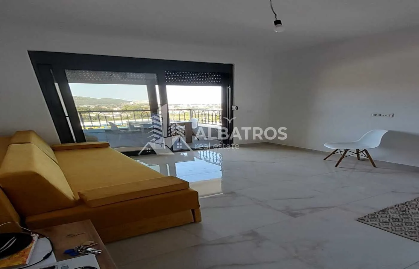 Living room with a sofa and access to the terrace.