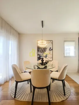 Dining area with a round glass table and modern chairs. - image 9