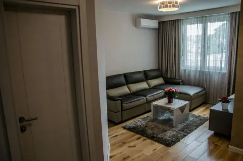 Living room with a sectional sofa and a coffee table. - image 4