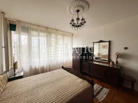 Furnished bedroom with a large double bed and dresser. - image 8