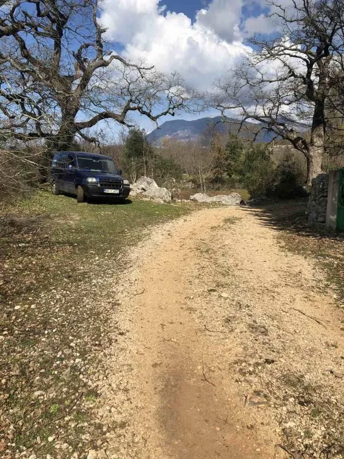 Zemljište sa pristupnim putem i parkiranim kombijem u prirodi.