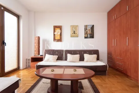 Living room with a sofa, wooden coffee table, built-in wardrobe, and access to the terrace. - image 2