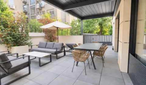 Spacious covered terrace with seating set and dining table. - image 13