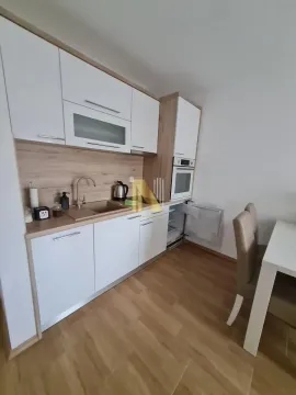 Modern kitchen with white cabinets and wooden details. - image 11