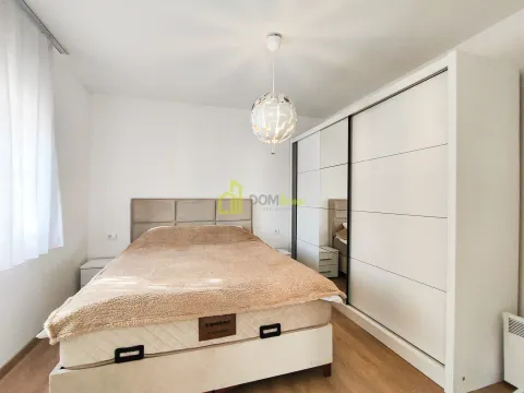 Bedroom with a double bed and a large white wardrobe. - image 17
