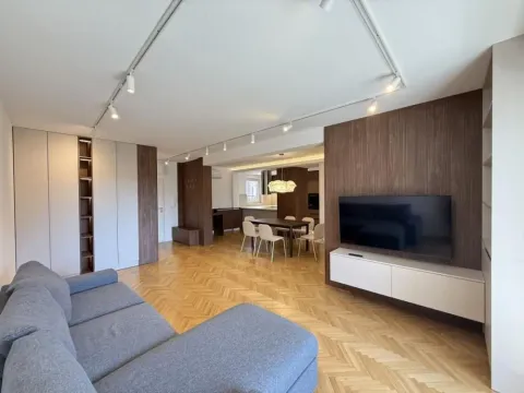 Spacious living room connected to the dining area and kitchen. - image 2
