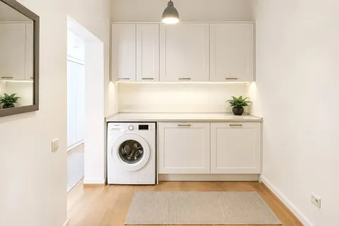 Modern white kitchen with a built-in washing machine. - image 15
