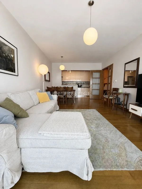 Spacious living room with a sofa set and a dining area in the background.