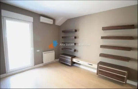 Living room with wall shelves, air conditioning, and a door leading to the terrace. - image 10