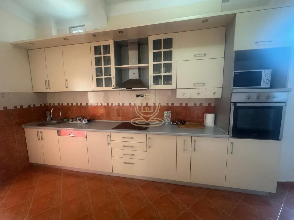 Kitchen equipped with light-colored cabinetry and built-in appliances.