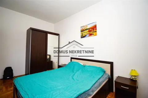 Bedroom with a double bed, wardrobe, and a bedside table. - image 8