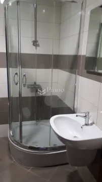 Bathroom with a shower cabin and a washbasin. - image 4