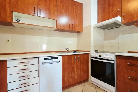Small kitchen with wooden cabinets, a sink, and white appliances. - image 14