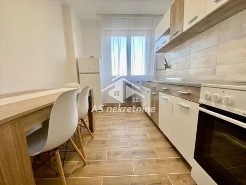 Kitchen equipped with cabinetry and a dining table next to the window. - image 3