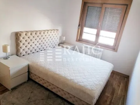 Furnished bedroom with a double bed, nightstands, and a window. - image 7