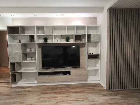 Large wall unit with a television and open shelving in the living room. - image 3