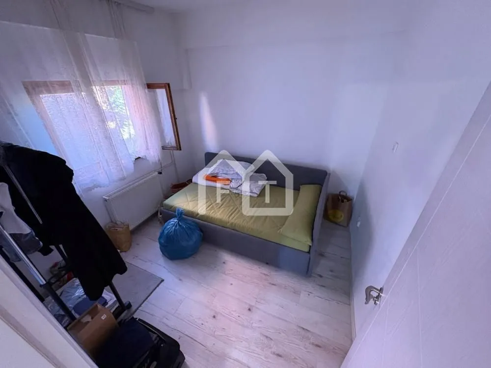 Small bedroom with a bed and a window.