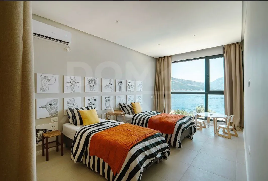 Children's bedroom with two beds and sea view.