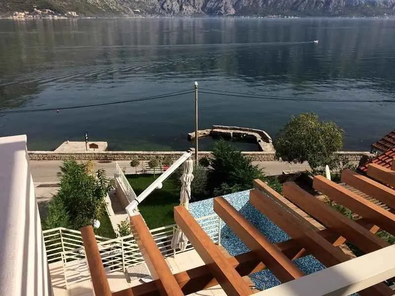 Pogled sa terase na bazen i more u daljini.